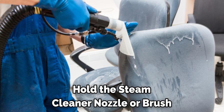 Hold the Steam Cleaner Nozzle or Brush