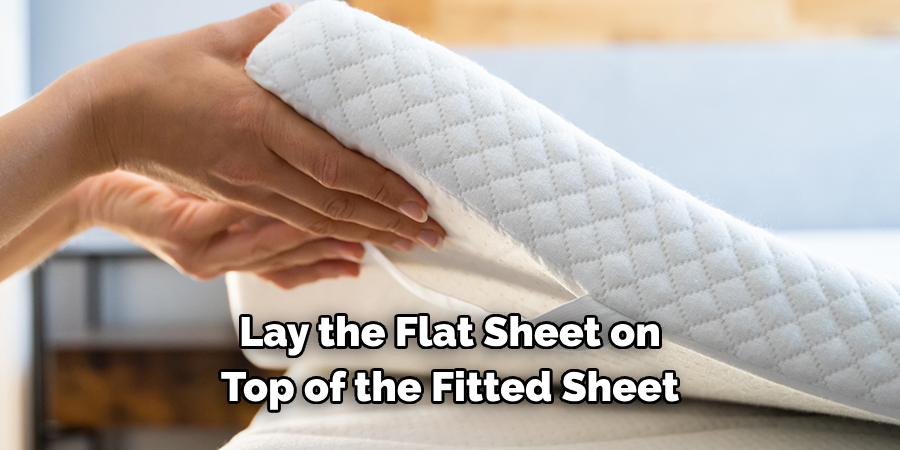 Lay the Flat Sheet on Top of the Fitted Sheet