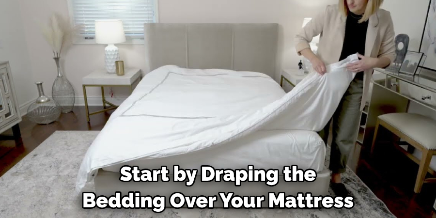Start by Draping the Bedding Over Your Mattress