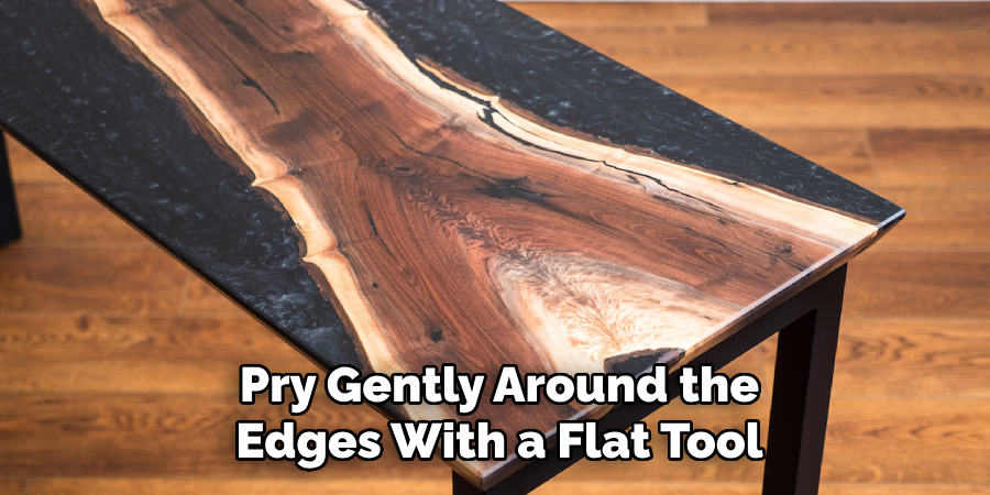 Pry Gently Around the Edges With a Flat Tool